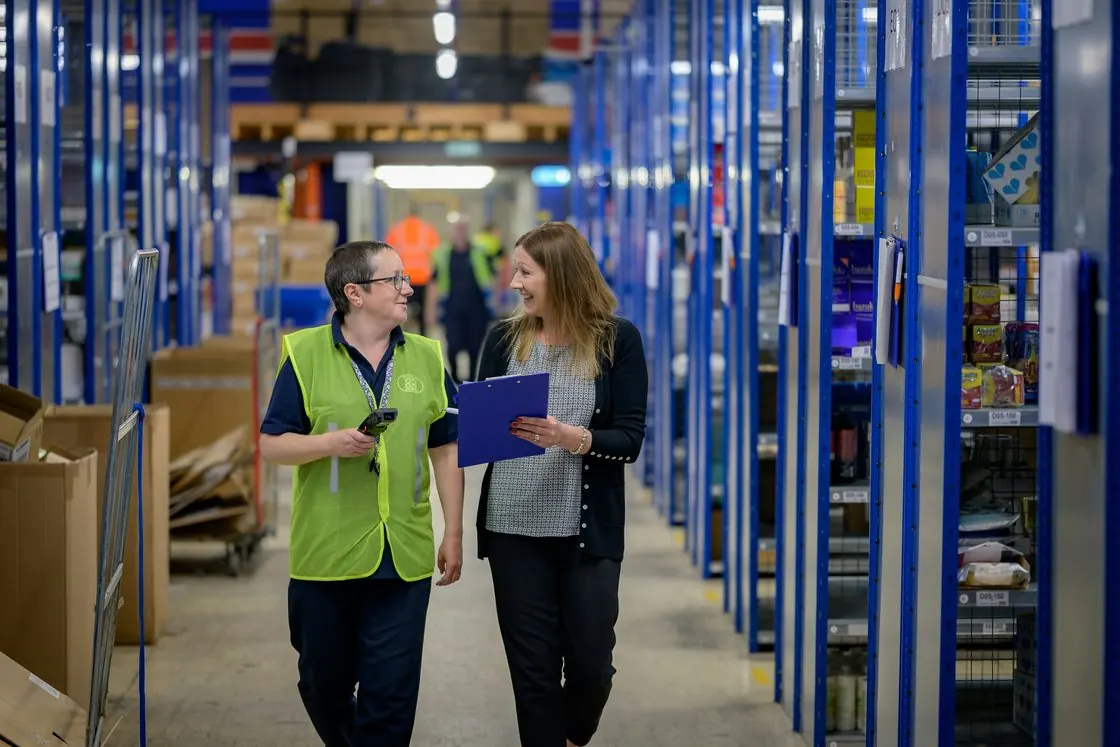 Two operators coordinating on the warehouse floor